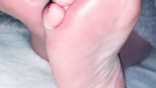 She shows me her sexy meaty feet with pink nails while watching TV