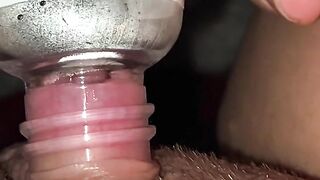 Horny and desperate girl uses a bottle to suck clit