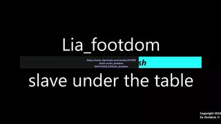 Foot slave lies under the table