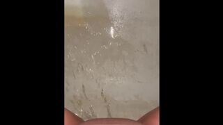 Girl pees in the tub shot from above